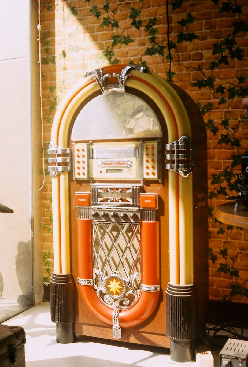 brass and red telephone booth